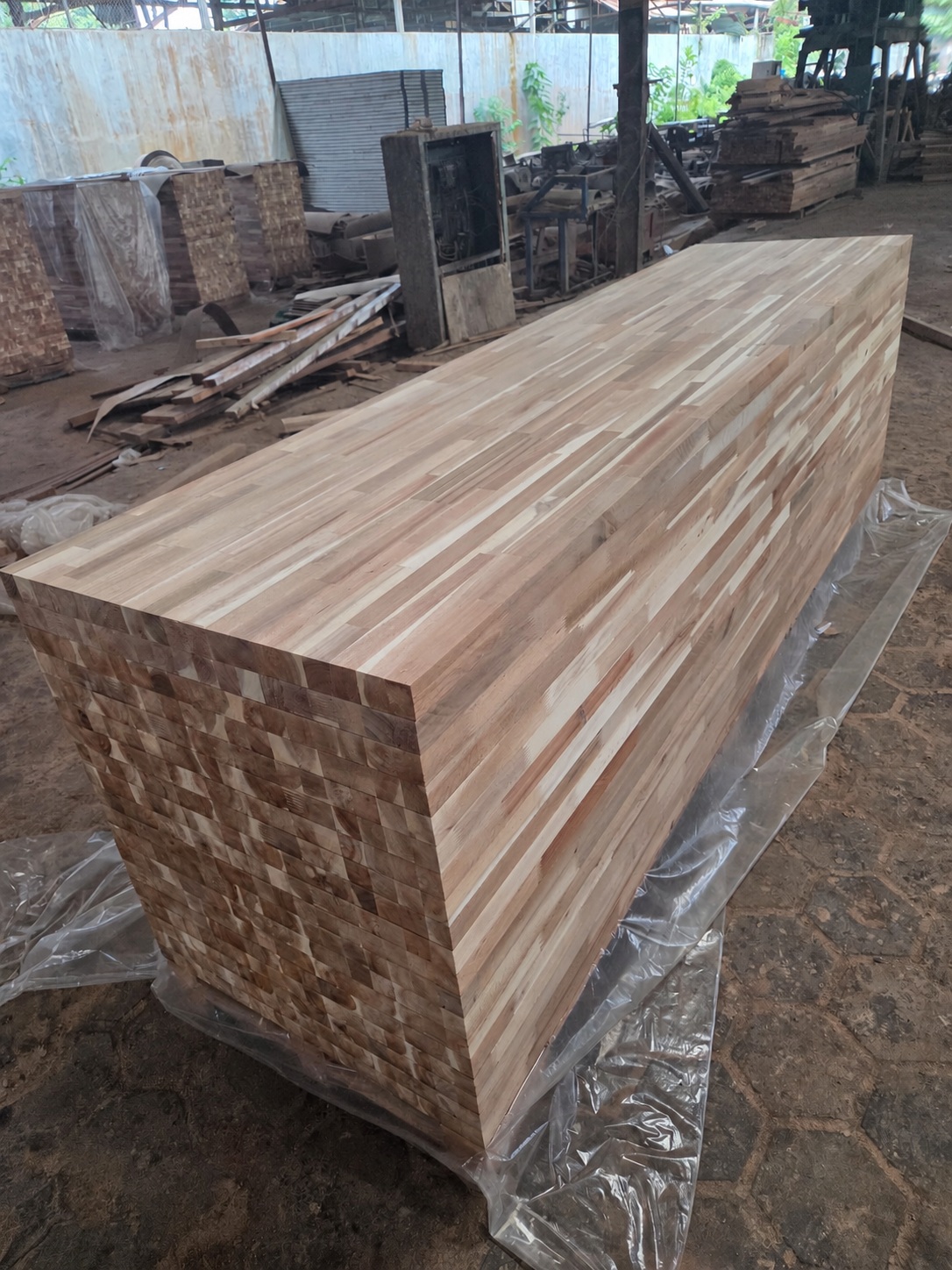 Stacks of butcher block panels in an Indonesian production workshop